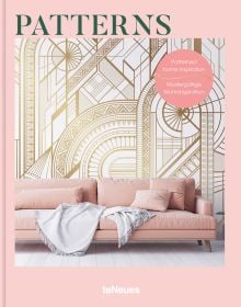 White and gold patterned wallpaper, pale pink sofa below, PATTERNS, in green font above.