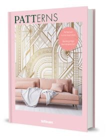 Book cover of Patterns: Patterned Home Inspiration, with white and gold patterned wallpaper, with pale pink sofa below. Published by teNeues Books.