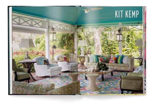 Book cover of Andrew Martin Interior Design Review Vol. 26, featuring a framed picture of Grace Jones wearing crown, with cigarette between teeth, hanging above an orange chair. Published by teNeues Books.