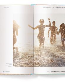 Beach landscape with people in the water, under a hazy sun, on cover of 'Beachlife', by teNeues Books.