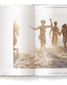 Beach landscape with people in the water, under a hazy sun, on cover of 'Beachlife', by teNeues Books.