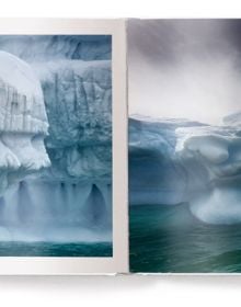 'GREENLAND', in grey font to bottom edge of white landscape book cover, by teNeues Books.