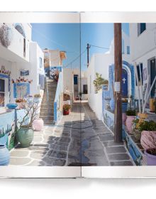 Bright blue and pale green sea of Greek island, small white boat floating to lower right, on white cover, 'CYCLADES', in white font below.