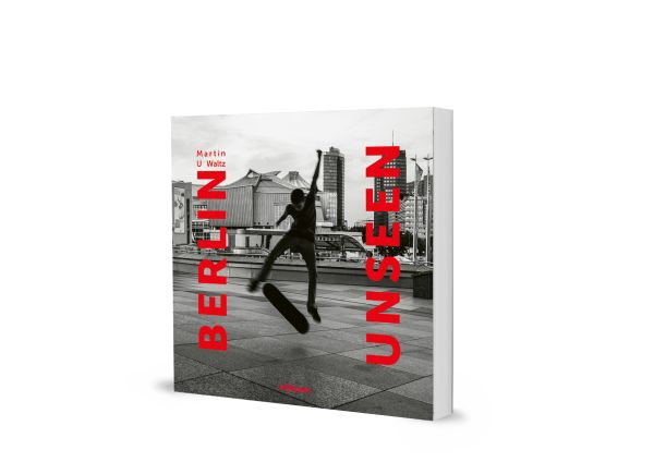 Book cover of Berlin Unseen, featuring a skateboarder performing a trick in the air, with city architecture behind. Published by teNeues Books.