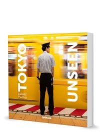 Book cover of Tokyo Unseen, with a subway staff member standing next to speeding yellow train. Published by teNeues Books.