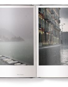Book cover of Lost in the Beauty of Bad Weather, with a sheep walking through snowy residential street at night. Published by teNeues Books.