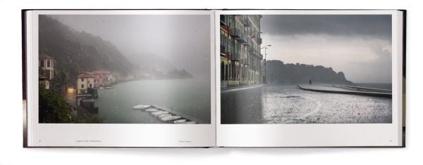 Book cover of Lost in the Beauty of Bad Weather, with a sheep walking through snowy residential street at night. Published by teNeues Books.