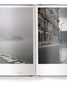 Book cover of Lost in the Beauty of Bad Weather, with a sheep walking through snowy residential street at night. Published by teNeues Books.