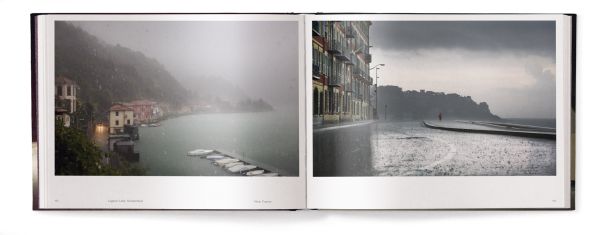 Book cover of Lost in the Beauty of Bad Weather, with a sheep walking through snowy residential street at night. Published by teNeues Books.