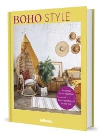 Large rattan chair draped with mustard coloured ceiling fabric, floppy hats on wall, on yellow cover of 'Boho Style, Bohemian Home Inspiration', by teNeues Books.