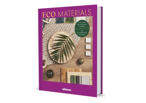 Aerial view of wood floor with woven rug, wooden plate with green palm leaf, on purple cover of 'Eco Materials, Decorating with Ecological Materials', by teNeues Books.
