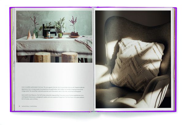 Aerial view of wood floor with woven rug, wooden plate with green palm leaf, on purple cover of 'Eco Materials, Decorating with Ecological Materials', by teNeues Books.