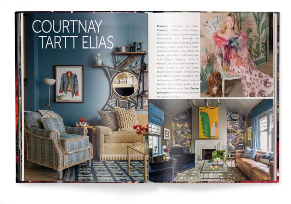 Interior living room of La Maison Semonville with stone fireplace, framed paintings and plush furniture, on cover of 'Andrew Martin Interior Design Review Vol. 27', by teNeues Books.