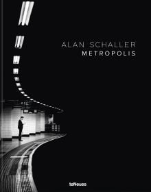 Low-lit metro with lone commuter standing by the tracks, on cover of 'Metropolis', by teNeues Books.