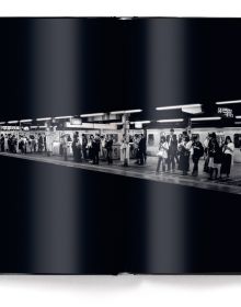 Low-lit metro with lone commuter standing by the tracks, on cover of 'Metropolis', by teNeues Books.