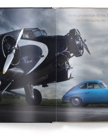 Front end of silver Porsche 356/1 and silver Porsche Vision 357, on cover of 'Porsche - A Passion for Power, Iconic Sports Cars since 1948', by teNeues Books.