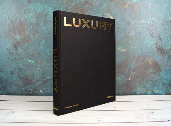 Black textured cover with gold capitalised font to top of 'Luxury', by teNeues Books.