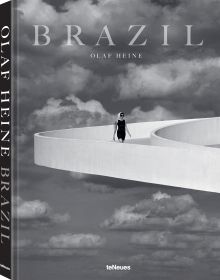 Book cover of Olaf Heine's Brazil, with a figure walking down a white raised platform on modern building, with sky behind. Published by teNeues Books.