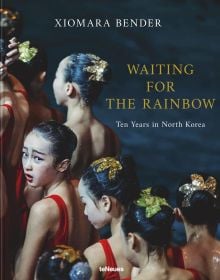 Book cover of Xiomara Bender's Waiting for the Rainbow: Ten Years in North Korea, with a group of dancers lining up in red costumes. Published by teNeues Books.