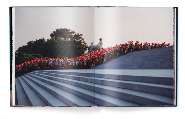 Book cover of Xiomara Bender's Waiting for the Rainbow: Ten Years in North Korea, with a group of dancers lining up in red costumes. Published by teNeues Books.