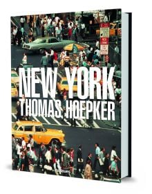 Aerial view of busy New York street with people crossing the road, and yellow taxis, on cover of Thomas Hoepker's photobook. Published by teNeues Books.