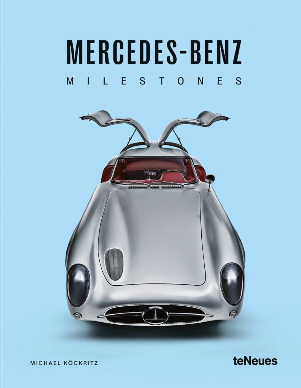 Book cover of Michael Köckritz's car guide, Mercedes-Benz Milestones, featuring a silver Mercedes-Benz 300 SLR gullwing Uhlenhaut, with doors open. Published by White Star.