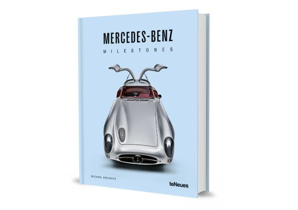 Book cover of Michael Köckritz's car guide, Mercedes-Benz Milestones, featuring a silver Mercedes-Benz 300 SLR gullwing Uhlenhaut, with doors open. Published by White Star.