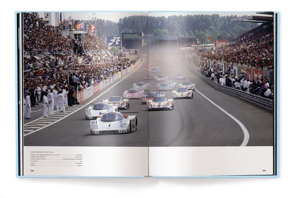 Book cover of Michael Köckritz's car guide, Mercedes-Benz Milestones, featuring a silver Mercedes-Benz 300 SLR gullwing Uhlenhaut, with doors open. Published by White Star.