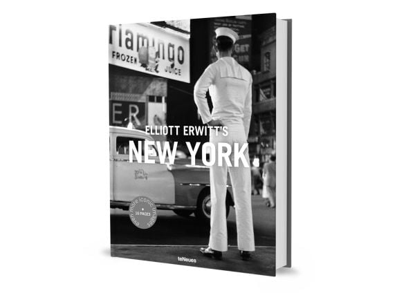Man wearing white sailor's clothes and hat, with his back to viewer, staring across busy city street, on cover of 'Elliott Erwitt’s New York', by teNeues Books.