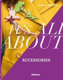 Book cover of Suzanne Middlemass's It’s All About Accessories, with a model wearing a yellow jacket and two large brooches to right lapel. Published by teNeues Books.