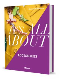 Book cover of Suzanne Middlemass's It’s All About Accessories, with a model wearing a yellow jacket and two large brooches to right lapel. Published by teNeues Books.
