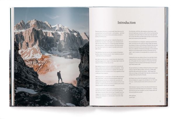 Book cover of Escape: Discovering the Dolomites: A Visual Journey and Adventures; featuring an adventurer standing on top of the Dolomite Mountains. Published by teNeues Books.