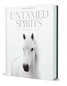 Book cover of Drew Doggett's Untamed Spirits: Horses from Around the World, with a white horse. Published by teNeues Books.