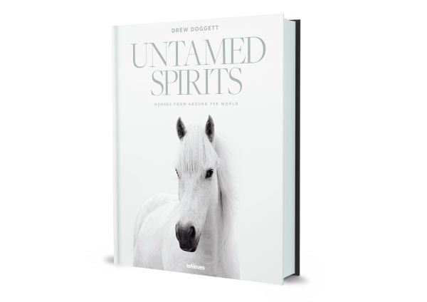 Book cover of Drew Doggett's Untamed Spirits: Horses from Around the World, with a white horse. Published by teNeues Books.