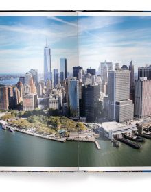 Book cover of BIG NEW YORK: The Most Iconic Photos, with the evening city skyline behind a large stencil of title. Published by teNeues Books.