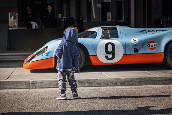 Book cover of Michael Köckritz's The Porsche Book, with a light blue Porsche 911 S-T 2024. Published by teNeues Books.