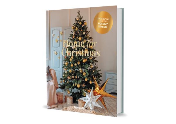 Book cover of Claire Bingham's Home for Christmas, with an interior living room with wood floors and a green Christmas tree decorated with gold baubles. Published by teNeues Books.