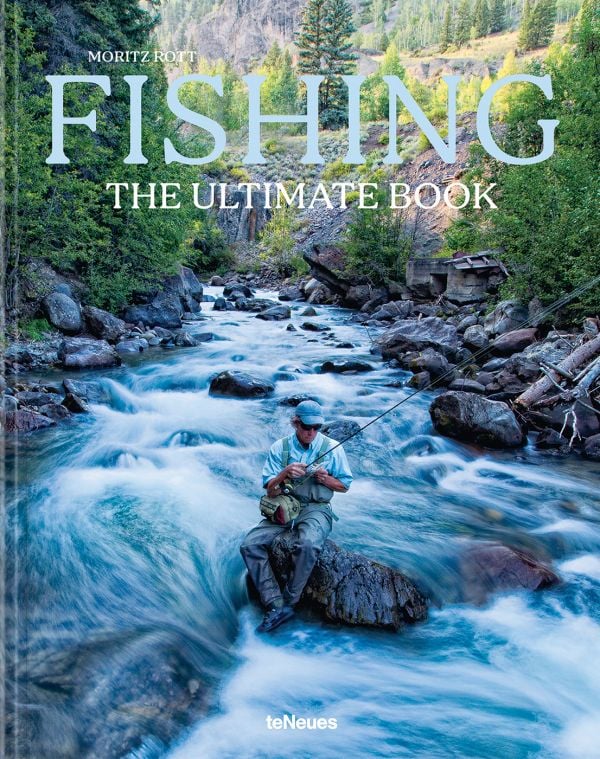 Book cover of Fishing: The Ultimate Book, with a fisherman sitting on a rock in the middle of a fast flowing river. Published by teNeues Books.