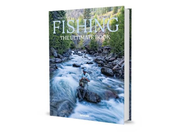 Book cover of Fishing: The Ultimate Book, with a fisherman sitting on a rock in the middle of a fast flowing river. Published by teNeues Books.