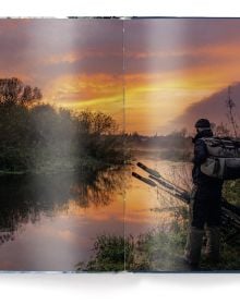 Book cover of Fishing: The Ultimate Book, with a fisherman sitting on a rock in the middle of a fast flowing river. Published by teNeues Books.