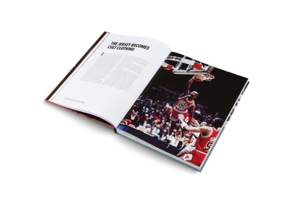 Book cover of Basketball: The Ultimate Book, with an aerial view of two players on court with orange ball. Published by teNeues Books.