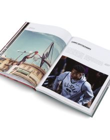 Book cover of Basketball: The Ultimate Book, with an aerial view of two players on court with orange ball. Published by teNeues Books.