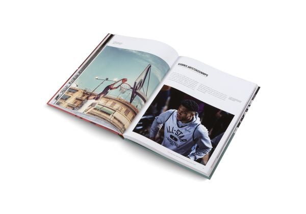 Book cover of Basketball: The Ultimate Book, with an aerial view of two players on court with orange ball. Published by teNeues Books.