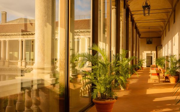 Book cover of Grand Tour Italy: The Renaissance of Refined Travel; featuring a view the Rialto Bridge from a window. Published by teNeues Books.
