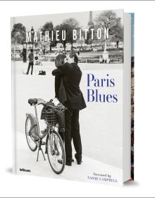 Book cover of Paris Blues, with a couple embracing, and a push bike on a stand behind them. Published by teNeues Books.
