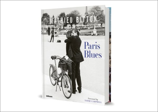 Book cover of Paris Blues, with a couple embracing, and a push bike on a stand behind them. Published by teNeues Books.