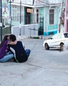 Book cover of Thomas Hoepker: Stories of Humanity; featuring a child on a cobbled street giving a bird some food. Published by teNeues Books.