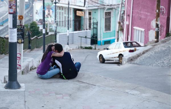 Book cover of Thomas Hoepker: Stories of Humanity; featuring a child on a cobbled street giving a bird some food. Published by teNeues Books.