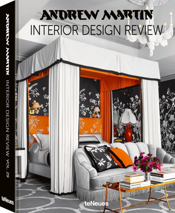 Book cover of Andrew Martin Interior Design Review Vol. 29; featuring a four poster bed with long white drapes and floral wallpaper. Published by teNeues Books.