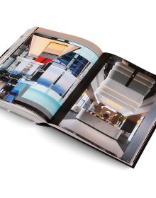 Book cover of Andrew Martin Interior Design Review Vol. 29; featuring a four poster bed with long white drapes and floral wallpaper. Published by teNeues Books.